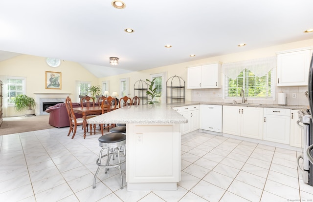 17 Saint George Pl Unit 17, Newtown, CT 06482 - kitchen with a sink, open floor plan, a breakfast bar area, a peninsula, and plenty of natural light
