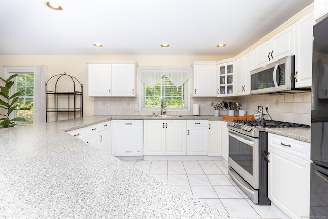 17 Saint George Pl Unit 17, Newtown, CT 06482 - kitchen featuring appliances with stainless steel finishes, a sink, healthy amount of natural light, white cabinets, and recessed lighting