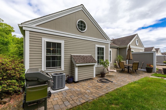 17 Saint George Pl Unit 17, Newtown, CT 06482 - rear view of house featuring central air condition unit, a patio, and a shingled roof