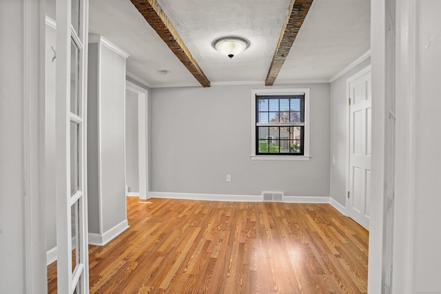 1975 Huntington Rd, Stratford, CT 06614 - spare room featuring beam ceiling, light wood-style floors, and ornamental molding