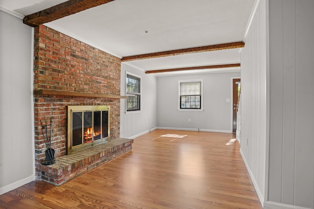 1975 Huntington Rd, Stratford, CT 06614 - unfurnished living room featuring beamed ceiling, light wood-style floors, a fireplace, and ornamental molding