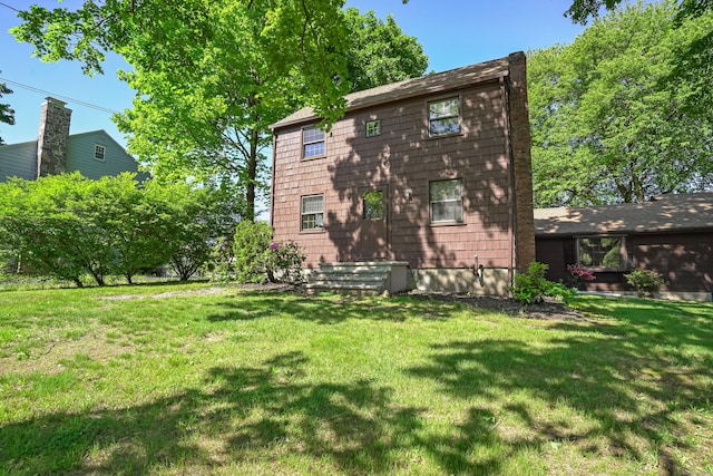 1975 Huntington Rd, Stratford, CT 06614 - rear view of property featuring a yard