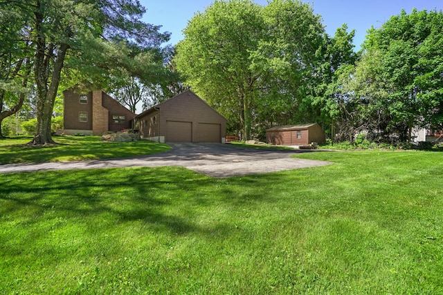 1975 Huntington Rd, Stratford, CT 06614 - view of front of property with an outbuilding, a detached garage, and a front lawn