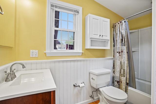 1975 Huntington Rd, Stratford, CT 06614 - full bathroom featuring a wainscoted wall, vanity, and shower / bath combo with shower curtain