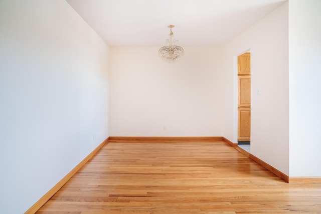 70 Grove Hill St Apt 3R, New Britain, CT 06052 - empty room featuring a chandelier, light wood-style flooring, and baseboards