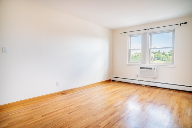 70 Grove Hill St Apt 3R, New Britain, CT 06052 - unfurnished room featuring wood finished floors, a wall mounted air conditioner, and a baseboard radiator