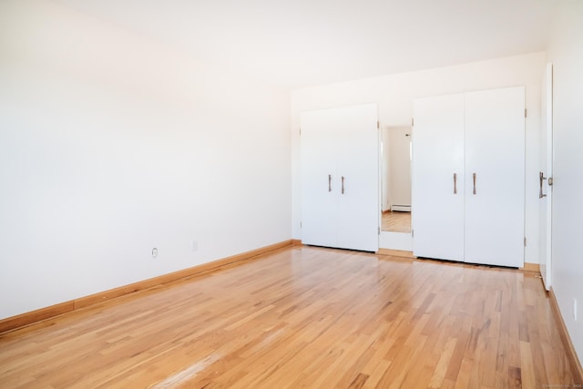 70 Grove Hill St Apt 3R, New Britain, CT 06052 - unfurnished bedroom with light wood-style flooring, baseboard heating, and baseboards