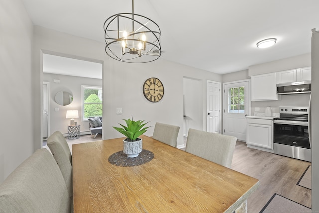 63 Bidwell St, Middletown, CT 06457 - dining area with healthy amount of natural light, a chandelier, and light wood-style flooring