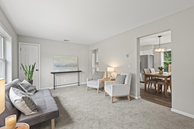 63 Bidwell St, Middletown, CT 06457 - living room featuring carpet, baseboards, and a chandelier