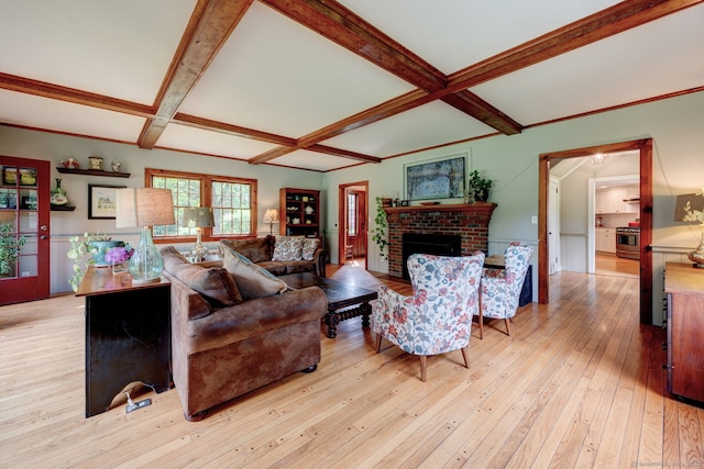 96 Middle Haddam Rd, East Hampton, CT 06456 - living room featuring coffered ceiling, a brick fireplace, beamed ceiling, light wood-style flooring, and wainscoting