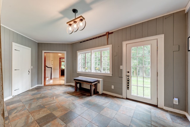 96 Middle Haddam Rd, East Hampton, CT 06456 - foyer featuring ornamental molding, stone tile flooring, baseboards, radiator, and wooden walls