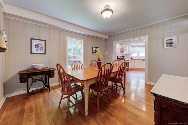 96 Middle Haddam Rd, East Hampton, CT 06456 - dining area featuring light wood finished floors, a decorative wall, and baseboards