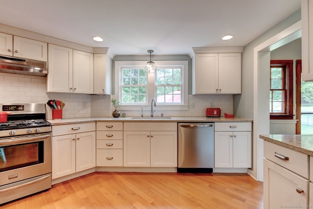 96 Middle Haddam Rd, East Hampton, CT 06456 - kitchen featuring stainless steel appliances, under cabinet range hood, a sink, light wood-style flooring, and recessed lighting