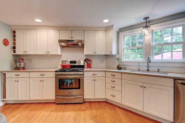 96 Middle Haddam Rd, East Hampton, CT 06456 - kitchen with stainless steel appliances, under cabinet range hood, a sink, light wood-style floors, and recessed lighting