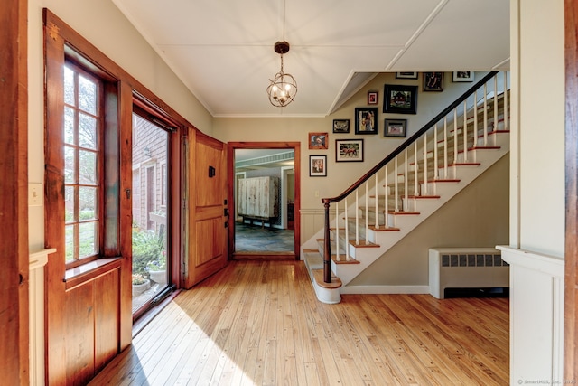 96 Middle Haddam Rd, East Hampton, CT 06456 - foyer with radiator heating unit, wood-type flooring, stairs, baseboards, and a chandelier