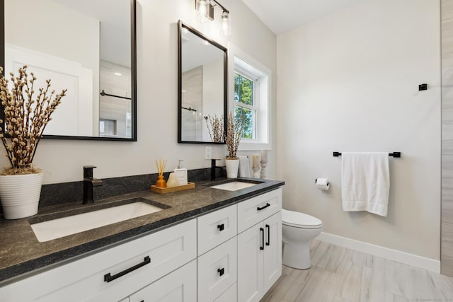 6 Turnpike Rd, Somers, CT 06071 - bathroom with double vanity, baseboards, toilet, a tile shower, and marble look tiles