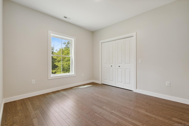 6 Turnpike Rd, Somers, CT 06071 - unfurnished bedroom featuring wood finished floors, baseboards, and a closet