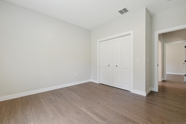 6 Turnpike Rd, Somers, CT 06071 - unfurnished bedroom with wood finished floors, baseboards, and a closet