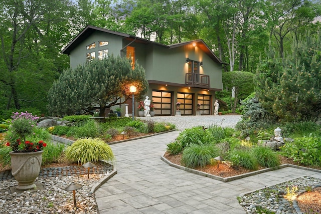 25 Ketcham Rd, Ridgefield, CT 06877 - view of front of property featuring a balcony, an attached garage, stucco siding, and driveway