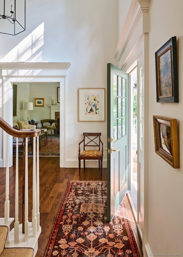 200 Sharon Mountain Rd, Sharon, CT 06069 - entrance foyer featuring dark wood-style flooring, a fireplace, a chandelier, a towering ceiling, and baseboards