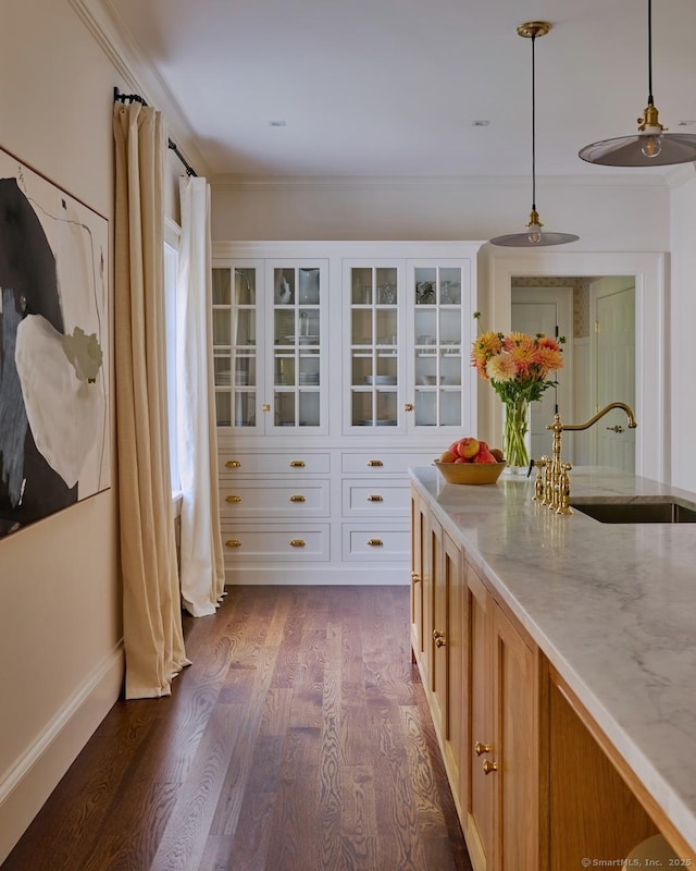 200 Sharon Mountain Rd, Sharon, CT 06069 - kitchen featuring a sink, light stone counters, glass insert cabinets, dark wood-type flooring, and ornamental molding