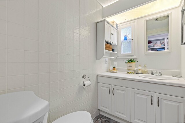 24 Boulder Trl, Killingworth, CT 06419 - bathroom featuring toilet, vanity, and tile walls