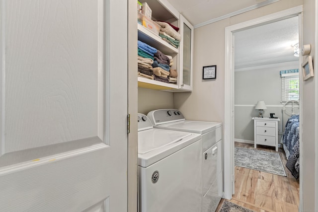 24 Boulder Trl, Killingworth, CT 06419 - laundry room with separate washer and dryer, crown molding, light wood-style floors, and cabinet space