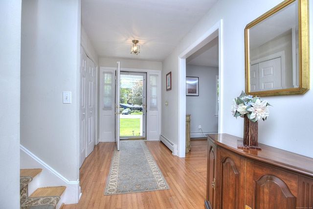 85 Oakridge Rd, Trumbull, CT 06611 - foyer with baseboard heating, light wood-style flooring, a baseboard radiator, stairway, and baseboards