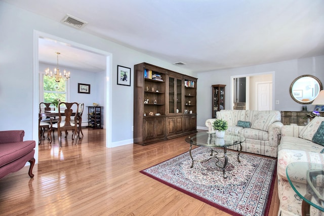 85 Oakridge Rd, Trumbull, CT 06611 - living area featuring a chandelier, light wood-style floors, and baseboards