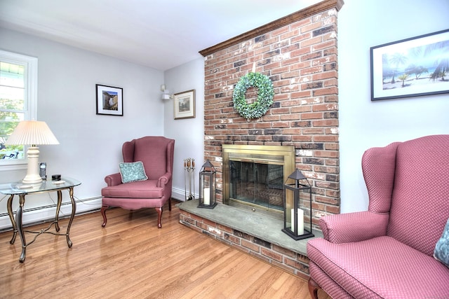 85 Oakridge Rd, Trumbull, CT 06611 - living area with wood finished floors, baseboard heating, and a fireplace