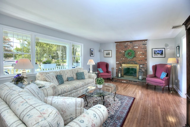 85 Oakridge Rd, Trumbull, CT 06611 - living area featuring a brick fireplace, wood finished floors, and baseboards
