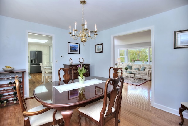 85 Oakridge Rd, Trumbull, CT 06611 - dining area featuring light wood-style flooring, a chandelier, and baseboards