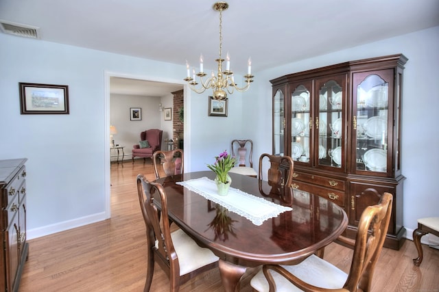 85 Oakridge Rd, Trumbull, CT 06611 - dining area featuring a chandelier, light wood-type flooring, and baseboards