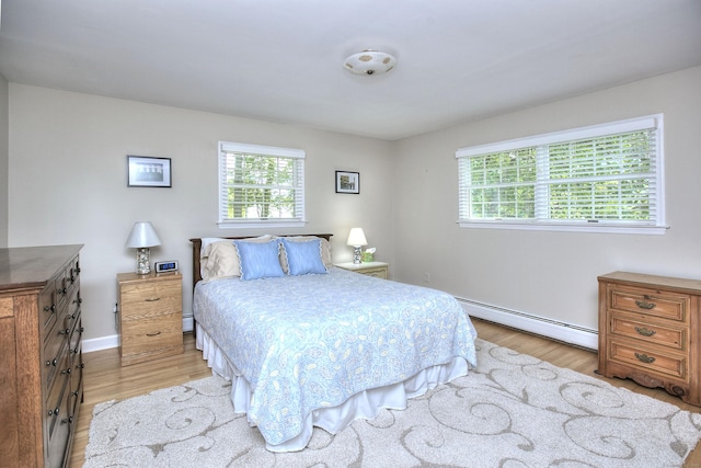 85 Oakridge Rd, Trumbull, CT 06611 - bedroom with a baseboard heating unit, light wood-style flooring, and baseboards