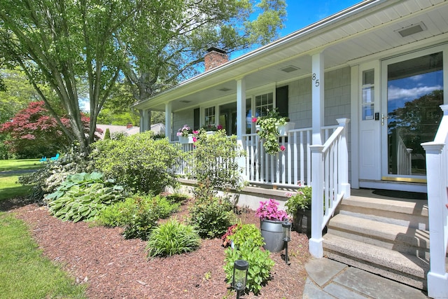 85 Oakridge Rd, Trumbull, CT 06611 - view of exterior entry featuring a chimney and covered porch