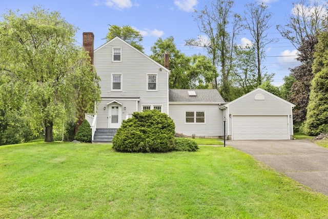 10 Paddock Pl, Milford, CT 06461 - view of front of house with a chimney, an outdoor structure, a front yard, and asphalt driveway