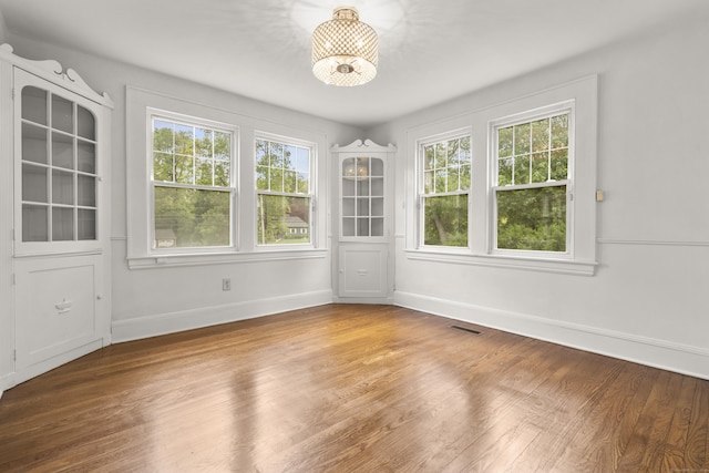 10 Paddock Pl, Milford, CT 06461 - spare room featuring plenty of natural light, baseboards, wood finished floors, and a chandelier