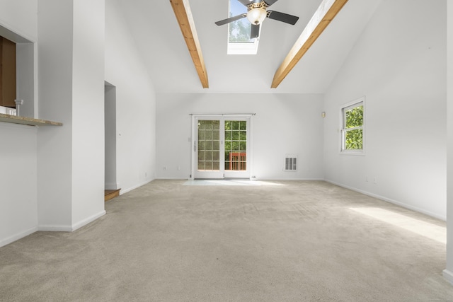 10 Paddock Pl, Milford, CT 06461 - unfurnished living room with a ceiling fan, a skylight, high vaulted ceiling, carpet flooring, and beamed ceiling
