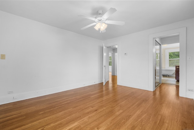 10 Paddock Pl, Milford, CT 06461 - spare room featuring light wood-style flooring, plenty of natural light, a ceiling fan, and baseboards