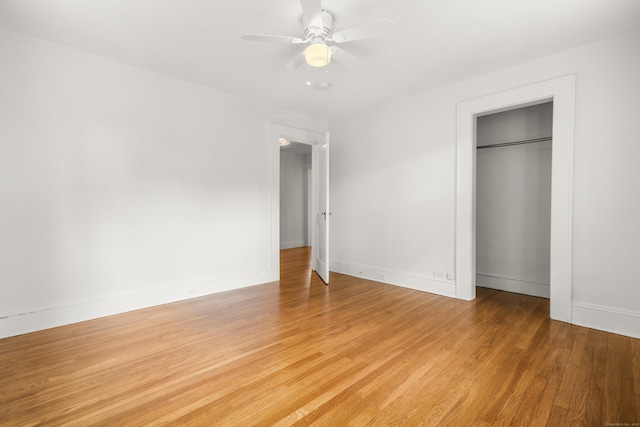 10 Paddock Pl, Milford, CT 06461 - unfurnished bedroom featuring light wood finished floors, a closet, baseboards, and a ceiling fan