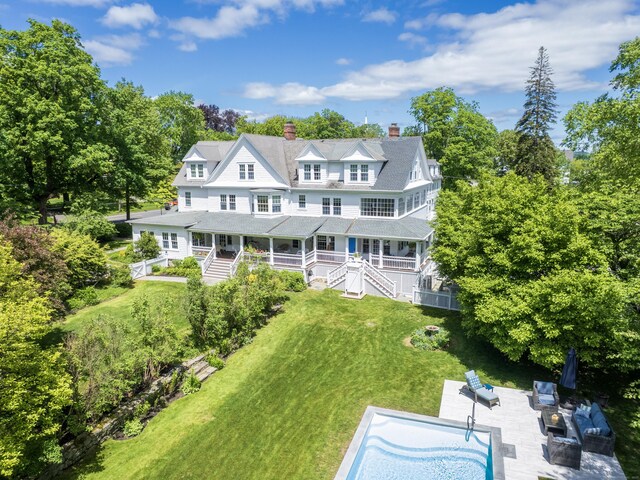 304 Main St, Ridgefield, CT 06877 - rear view of property with a chimney, covered porch, a yard, and an outdoor hangout area