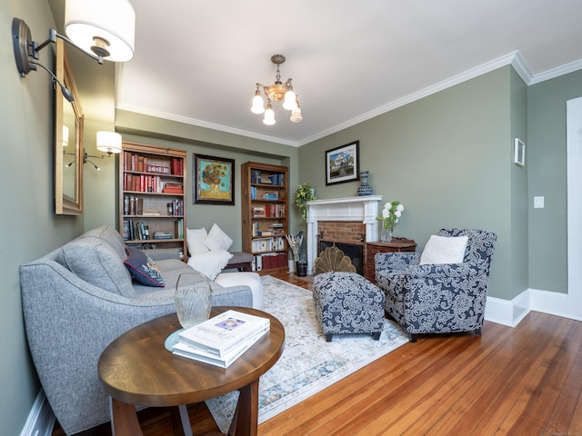 304 Main St, Ridgefield, CT 06877 - living area featuring a chandelier, wood finished floors, a fireplace, crown molding, and baseboards