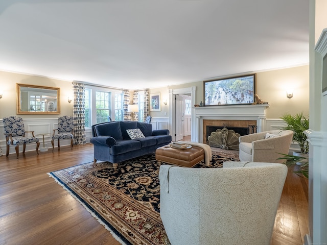 304 Main St, Ridgefield, CT 06877 - living area featuring a fireplace, a decorative wall, wood finished floors, healthy amount of natural light, and wainscoting