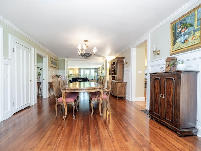304 Main St, Ridgefield, CT 06877 - dining room with a chandelier, a decorative wall, wood finished floors, and ornamental molding