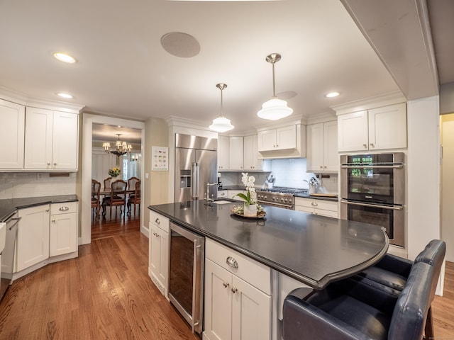 304 Main St, Ridgefield, CT 06877 - kitchen with high quality appliances, beverage cooler, dark countertops, a chandelier, and recessed lighting