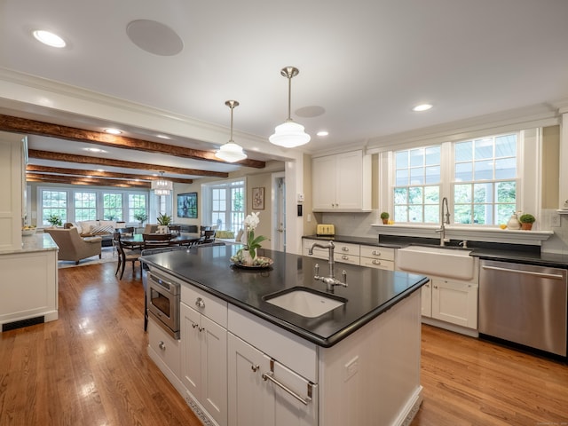 304 Main St, Ridgefield, CT 06877 - kitchen featuring appliances with stainless steel finishes, a sink, dark countertops, open floor plan, and recessed lighting