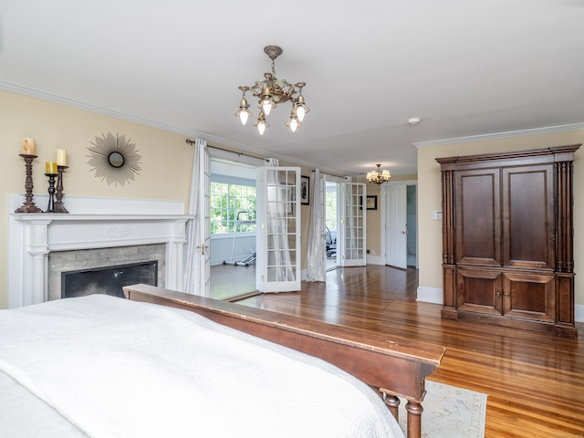 304 Main St, Ridgefield, CT 06877 - bedroom with a chandelier, ornamental molding, wood finished floors, access to outside, and a fireplace