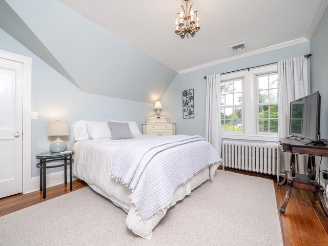 304 Main St, Ridgefield, CT 06877 - bedroom featuring radiator, wood finished floors, ornamental molding, a chandelier, and lofted ceiling