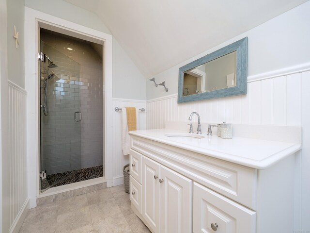 304 Main St, Ridgefield, CT 06877 - full bath featuring vanity, a shower stall, vaulted ceiling, a wainscoted wall, and a decorative wall