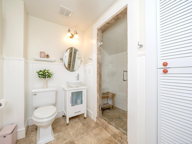 304 Main St, Ridgefield, CT 06877 - bathroom with toilet, a stall shower, wainscoting, and vanity